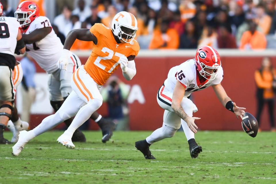 Georgia quarterback Carson Beck (15) fumbles the ball as Tennessee defensive lineman James Pearce Jr. (27) trails him, during a football game between Tennessee and Georgia at Neyland Stadium in Knoxville, Tenn., on Saturday, Nov. 18, 2023. Saul Young/News Sentinel / USA TODAY NETWORK