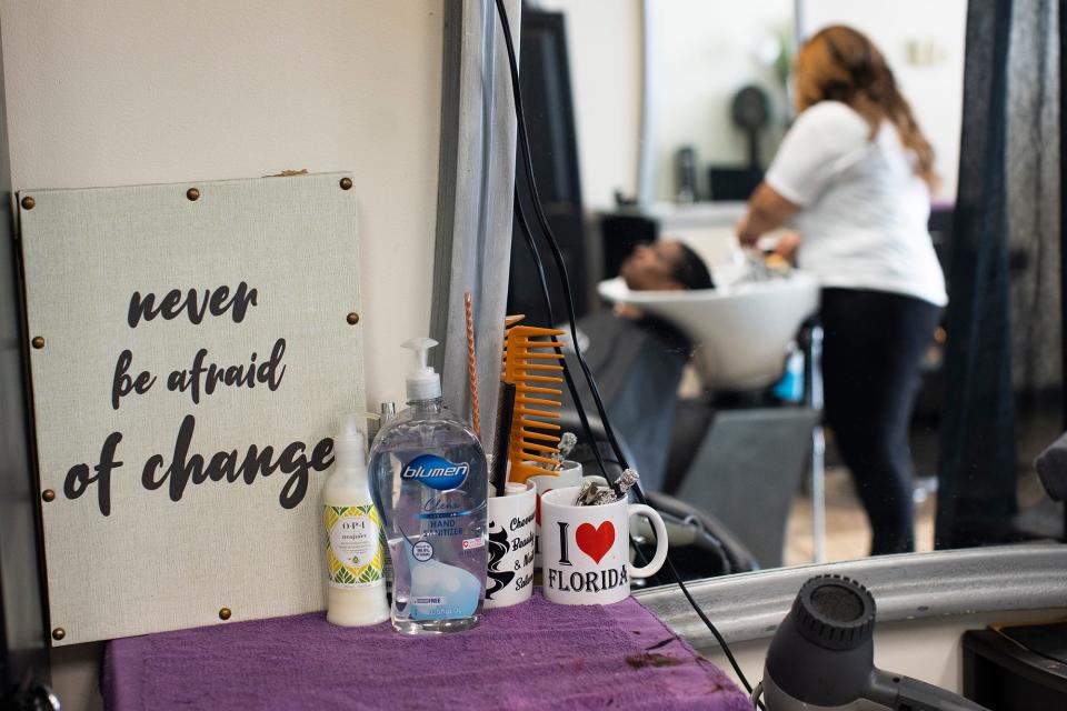 A sign at Cheveux Adorn Hair and Nail reads, "never be afraid of change."