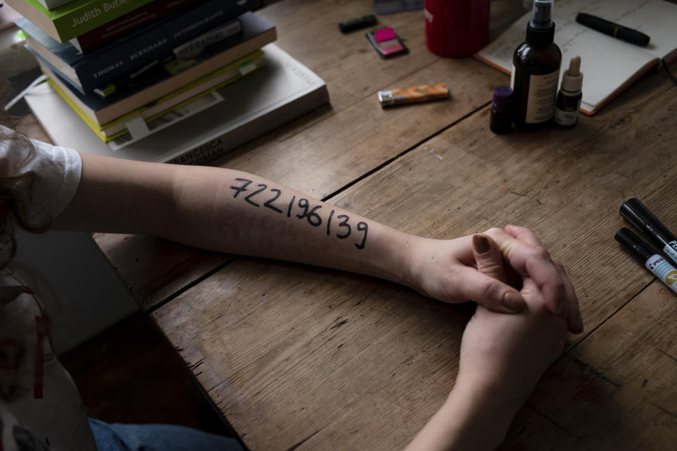 Nina Michnik, a Polish student of Arabic studies and philosophy shows her arm with the phone number of a legal counselor written on in Warsaw, Poland, Saturday, Nov. 21, 2020. Protesters write phone numbers of lawyers on their hands in case the are detained by police. (AP Photo/Agata Grzybowska)