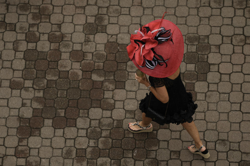 A race fan walks though the grounds of Churchill Downs before the 150th running of the Kentucky Derby horse race Saturday, May 4, 2024, in Louisville, Ky. (AP Photo/Charlie Riedel)