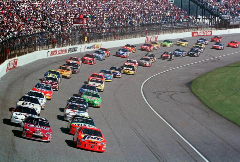 Ricky Rudd, front right, and Jeff Burton, front left, lead the field as they take the green flag to start the NASCAR Cup Series auto race at North Carolina Motor Speedway on Feb. 21, 1999.