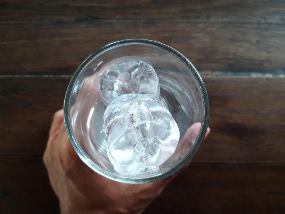 A glass with ice cubes.