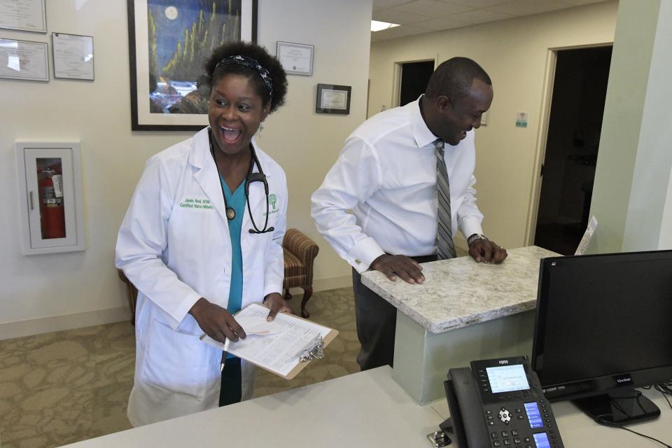 Registered nurse practitioner Jamie Neal shares a light moment between patients with her husband and CEO of Life Tree Women Care health center Derek Neal. The couple opened the clinic with focus on Black patients in June.