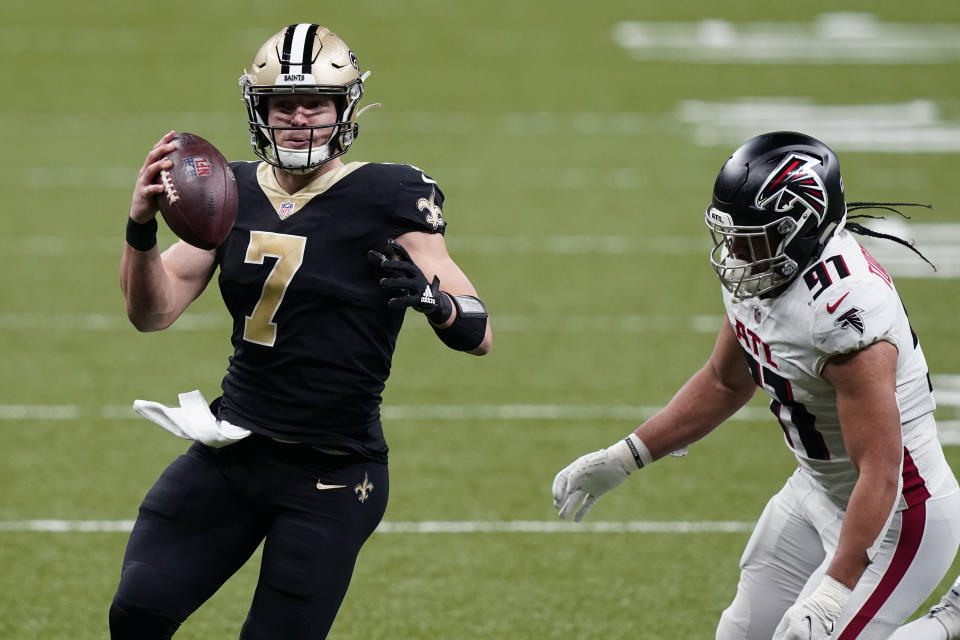 New Orleans Saints quarterback Taysom Hill (7) scrambles past Atlanta Falcons defensive tackle Jacob Tuioti-Mariner (91) in the first half of an NFL football game in New Orleans, Sunday, Nov. 22, 2020. (AP Photo/Butch Dill)