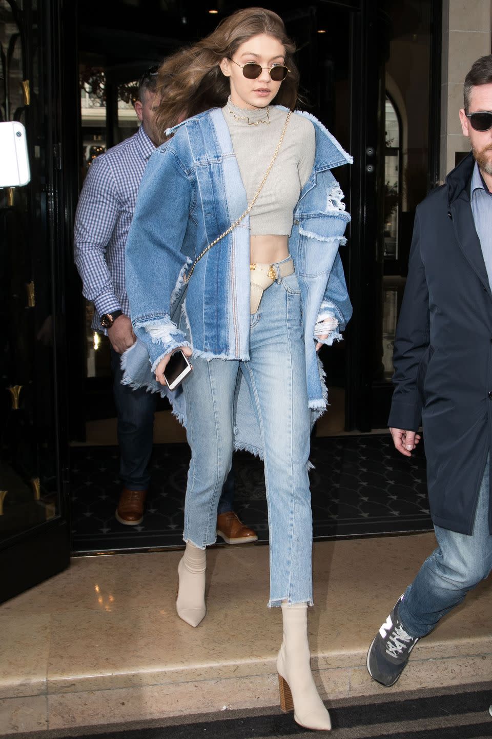 <p>In an oversized denim jacket, Topshop crop top, Sandro jeans, Tony Bianco ankle boots, and Krewe rounded sunglasses while out in Paris. </p>