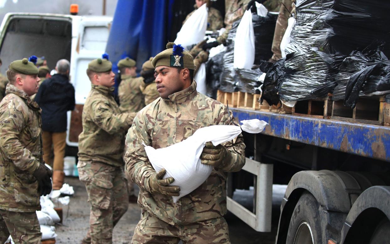 Soldiers from The Highlanders, 4th Battalion, the Royal Regiment of Scotland in Mytholmroyd to assist with flood defences - PA