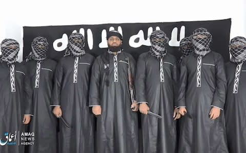 A group of men claiming to be the the Sri Lanka bomb attackers appear in an Isil propaganda video - Credit: Twitter