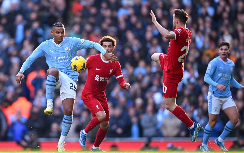 Manuel Akanji of Manchester City and Diogo Jota of Liverpool battle for possession during the Premier League match between Manchester City and Liverpool FC