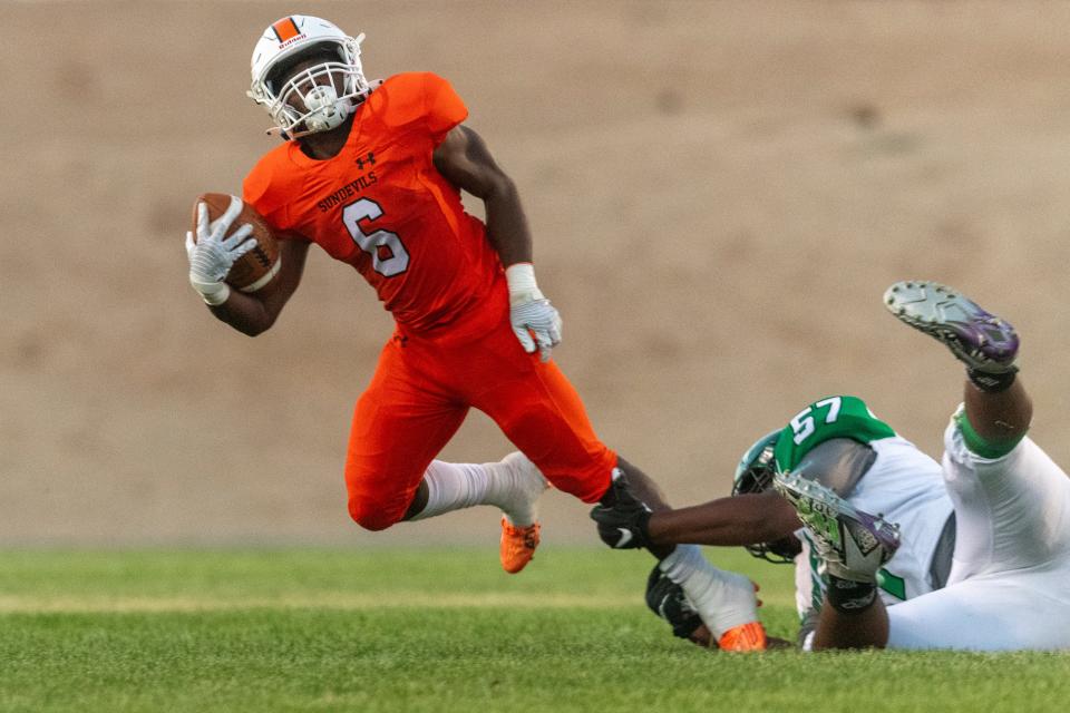 Apple Valley's Zyron Belcher escapes Victor Valley's Roman Paopao Jefferson during the first quarter of the 54th annual Bell Game on Friday, Sept. 8, 2023. The Sun Devils won 63-20, improving to 2-1 on the season.