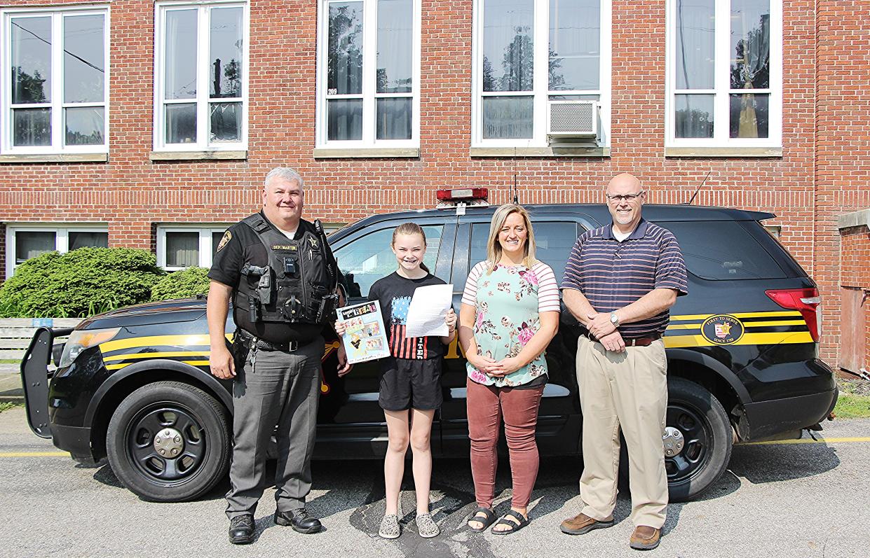 Pictured is DARE Essay Contest winners Emma Grimwood (second from left) with Ashland County Sheriff's Deputy Brian Martin, Mrs. Powers, Mr. Tim Keib.