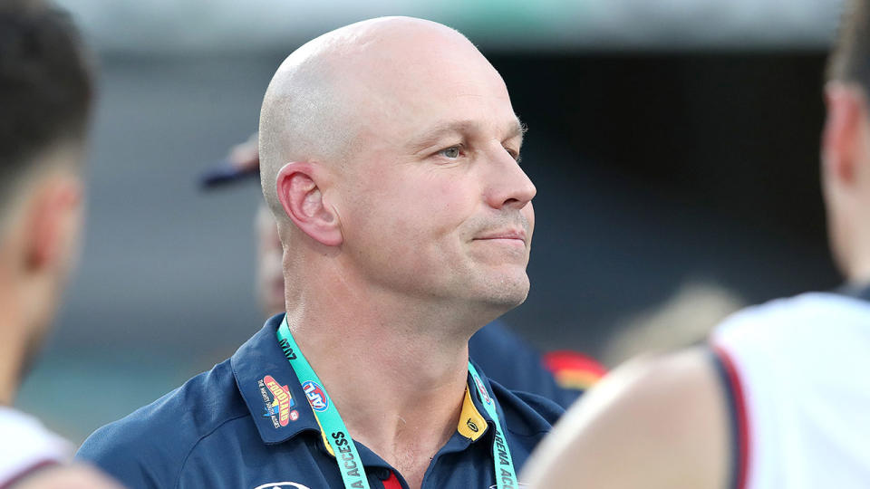 Seen here, Adelaide coach Matthew Nicks in a huddle with his players during an AFL match.