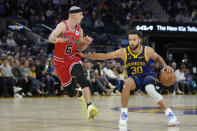 Golden State Warriors guard Stephen Curry (30) tries to get around Chicago Bulls guard Alex Caruso (6) during the first half of an NBA basketball game in San Francisco, Friday, Dec. 2, 2022. (AP Photo/Godofredo A. Vásquez)