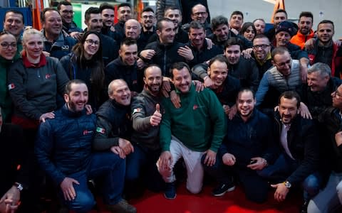 Matteo Salvini on the campaign trail with a group of factory workers in Basilicata - Credit: Getty