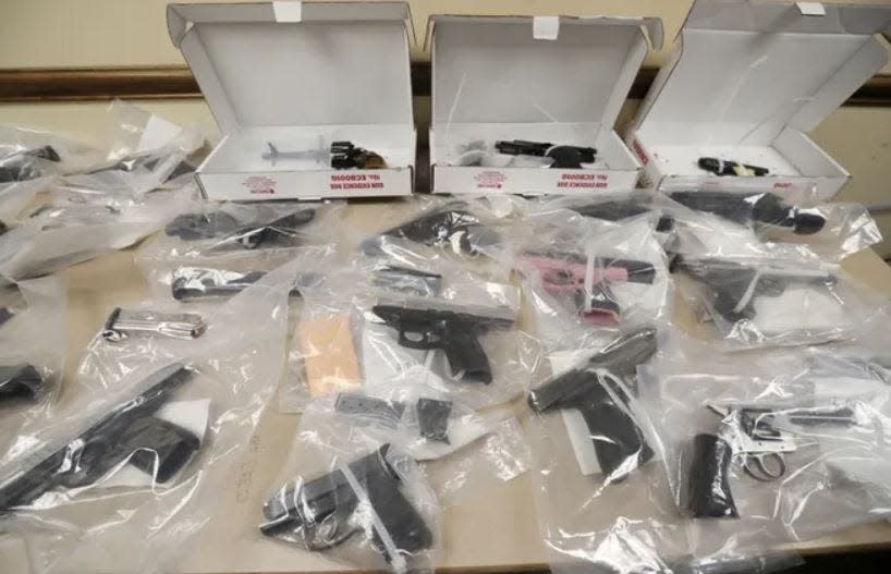 This file photo from 2019 shows a collection of guns confiscated by the Akron Police Department's Gun Violence Reduction Team that is part of the department's Street Narcotics Uniform Detail (SNUD).