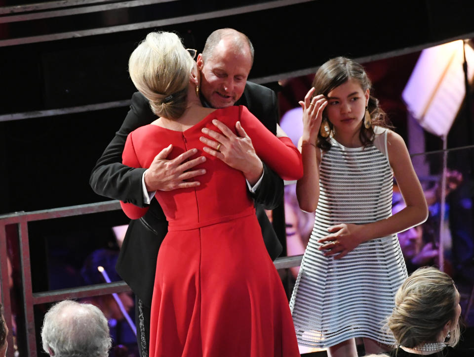 The actress, here hugging fellow nominee Woody Harrelson, tucked the pin into her low bun. (Photo: Kevin Winter/Getty Images)