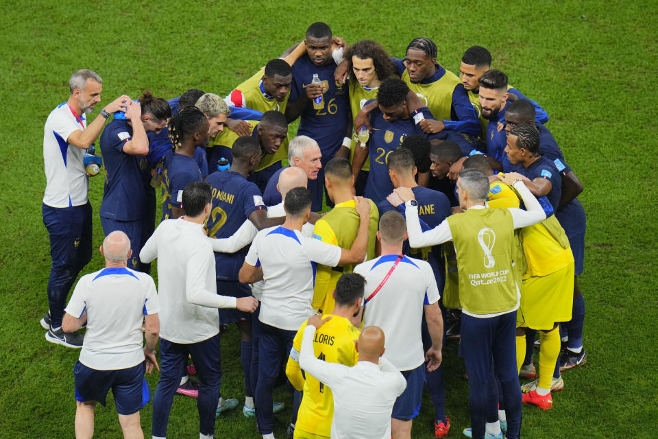 FILE - France's head coach Didier Deschamps talks with players before the start of the extra time during the World Cup final soccer match between Argentina and France at the Lusail Stadium in Lusail, Qatar, Sunday, Dec. 18, 2022. The penalty shootout is a tense battle of wills over 12 yards (11 meters) that has increasingly become a huge part of soccer and an unavoidable feature of the knockout stage in the biggest competitions. (AP Photo/Hassan Ammar, File)