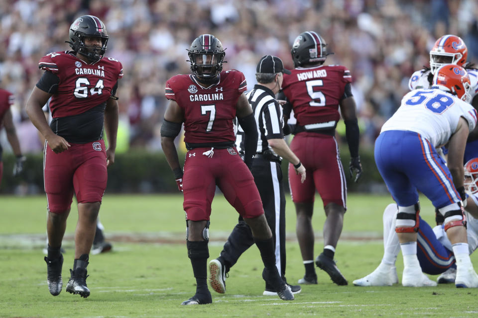 South Carolina defensive end Jordan Strachan (7) celebrates a sack with defensive lineman Xzavier McLeod (64) during the second half of the team'ss NCAA college football game against Florida on Saturday, Oct. 14, 2023, in Columbia, S.C. (AP Photo/Artie Walker Jr.)