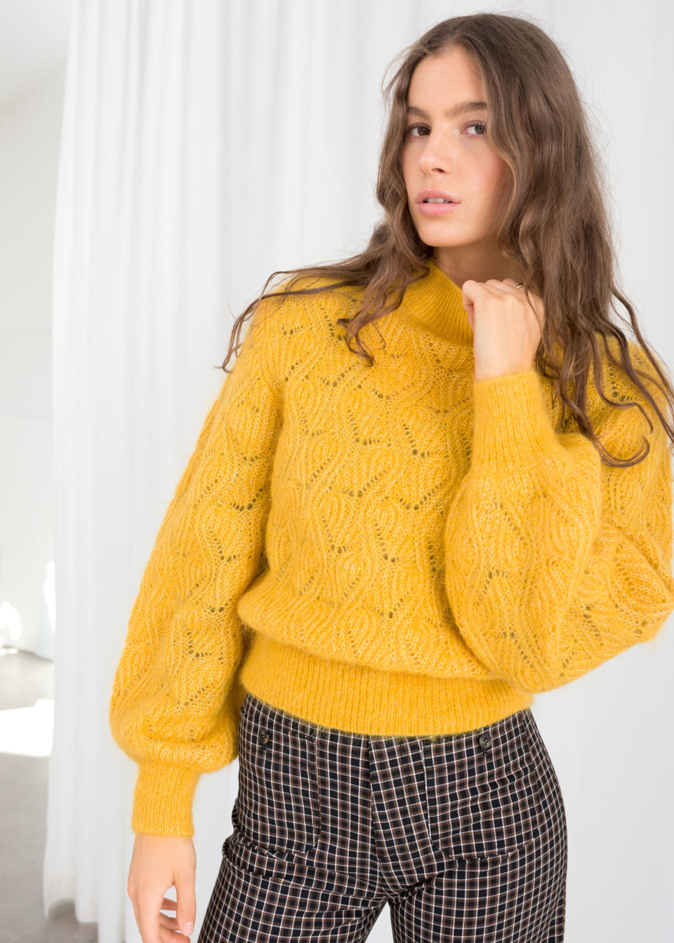 <strong><a href="https://www.stories.com/en_usd/clothing/all/product.eyelet-knit-wool-blend-sweater-mustard.0674190001.html" target="_blank" rel="noopener noreferrer">&amp; Other Stories eyelet knit wool blend sweater</a>, $89</strong>