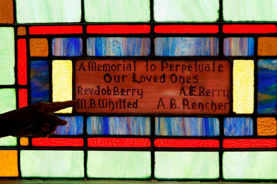 Retired Judge Beverly Scarlett points out the details of stained-glass windows at Dickerson Chapel AME Church on Thursday, April 18, 2024, in Hillsborough, N.C.