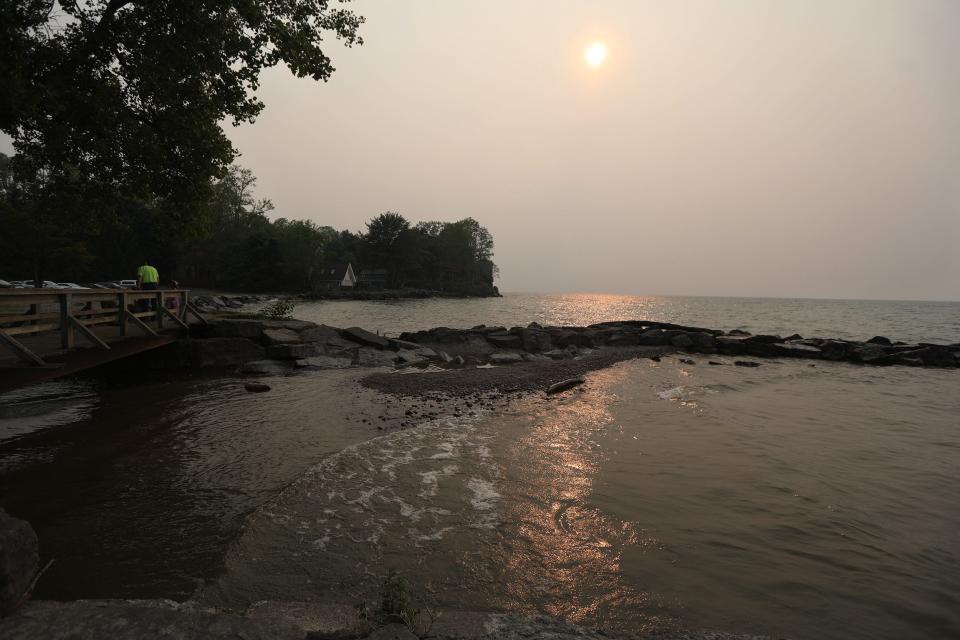 Smog from the wildfires in Canada have been making their way across the upper United States.  The sun has had an orange cast to it reflecting its color on Lake Ontario at Webster Park.