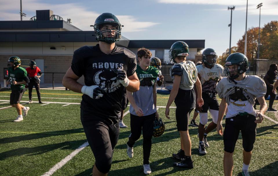 Avery Gach, 17, a junior at Birmingham Groves High School, jogs toward his teammates during an afternoon football practice in Beverly Hills on Tuesday, Oct. 24, 2023.