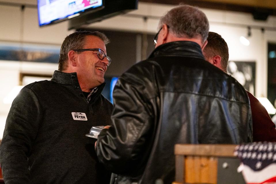 John Feyen, left, who was elected Larimer County sheriff, chats with others during a Larimer GOP watch party at Old Chicago in Fort Collins on Nov. 8, 2022.