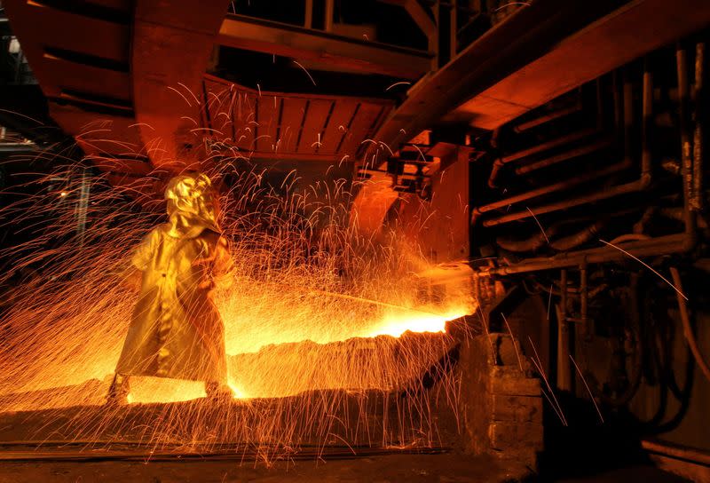 FILE PHOTO: A worker uses the tapping process to separate nickel ore from other elements at a nickel processing plant in Sorowako