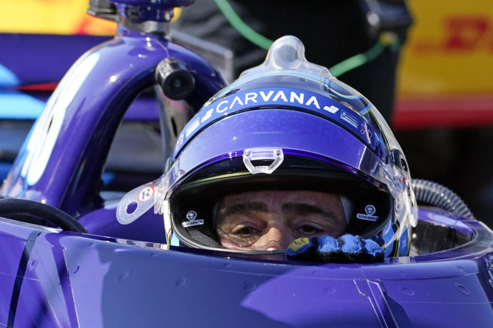 FILE - In this May 14, 2021, file photo, Jimmie Johnson climbs out of his car following practice for the IndyCar auto race at Indianapolis Motor Speedway in Indianapolis. Johnson is hopeful of testing in August at Homestead-Miami Speedway as part of a path toward running in the Indianapolis 500 in 2022. The seven-time NASCAR champion jumped this season to IndyCar and has competed in seven races for team owner Chip Ganassi. (AP Photo/Darron Cummings, File)