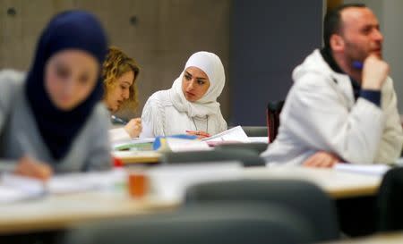 Migrants who worked as teachers in their home countries takes part in a programme to educate them for German schools at the University in Potsdam, Germany, April 14, 2016. REUTERS/Hannibal Hanschke