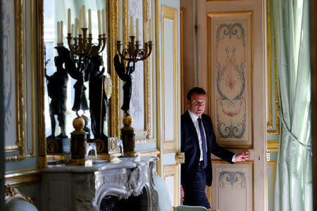 French President Emmanuel Macron walks out of his office at the Elysee Palace in Paris, France, May 23, 2017. REUTERS/Philippe Wojazer