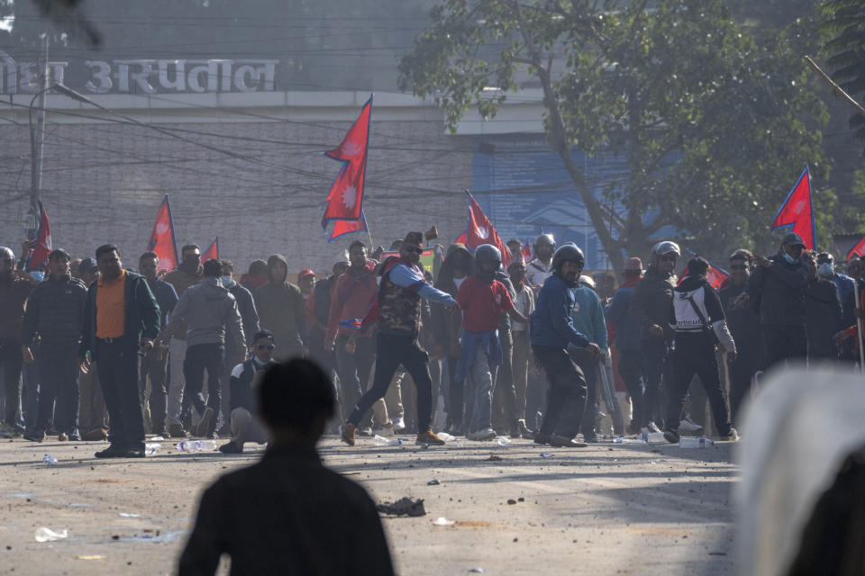 Protesters clash with policemen during a rally demanding a restoration of Nepal's monarchy in Kathmandu, Nepal, Thursday, Nov. 23, 2023. Riot police used batons and tear gas to halt tens of thousands of supporters of Nepal's former king demanding the restoration of the monarchy and the nation's former status as a Hindu state. Weeks of street protests in 2006 forced then King Gyanendra to abandon his authoritarian rule and introduce democracy. (AP Photo/Niranjan Shrestha)