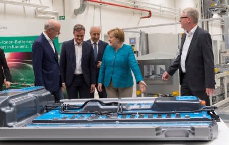 (L-R) Dieter Zetsche, Chairman of the Board of Management of Daimler AG and Head of Mercedes-Benz Cars, Markus Schaefer, Member of the Divisional Board of Mercedes-Benz Cars, Stanislaw Tillich, Minister President of the Free State of Saxony, German Chancellor Angela Merkel and Frank Blome, Managing Director of Deutsche ACCUMOTIVE GmbH & Co. KG, visit the Daimlers first battery factory prior to the beginning of the ground breaking ceremony for the second battery factory at Daimler subsidiary ACCUMOTIVE in Kamenz, Germany May 22, 2017. REUTERS/ Matthias Rietschel