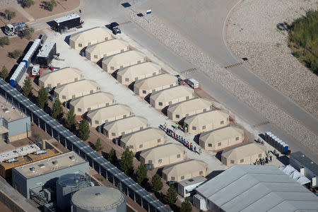 Immigrant children, many of whom have been separated from their parents under a new "zero tolerance" policy by the Trump administration, are being housed in tents next to the Mexican border in Tornillo, Texas, U.S. June 18, 2018. REUTERS/Mike Blake -RC188AFA93B0