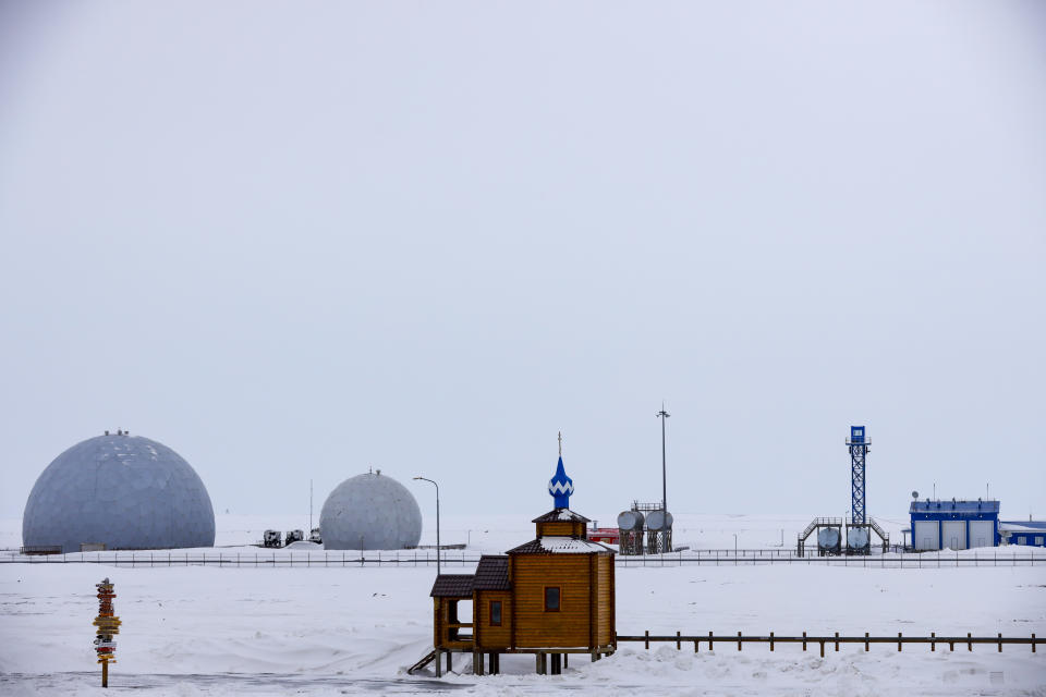 An Orthodox Church sits with a radar facility in the background on the Alexandra Land island near Nagurskoye, Russia, Monday, May 17, 2021. Bristling with missiles and radar, Russia's northernmost military base projects the country's power and influence across the Arctic from a remote, desolate island amid an intensifying international competition for the region's vast resources. Russia's northernmost military outpost sits on the 80th parallel North, projecting power over wide swathes of Arctic amid an intensifying international rivalry over the polar region's vast resources. (AP Photo/Alexander Zemlianichenko)