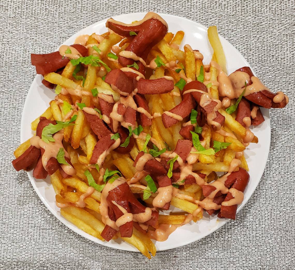 Known as salchipapas in Ecuador, these “doggy fries” are a platter of french fries and cut up hot dog wieners with homemade sauce layered on top.