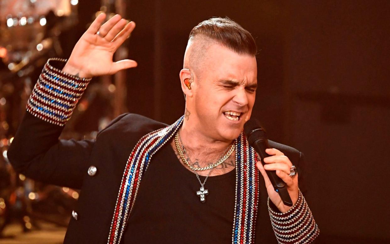 The life and times of Robbie Williams are to be brought to the silver screen - AFP