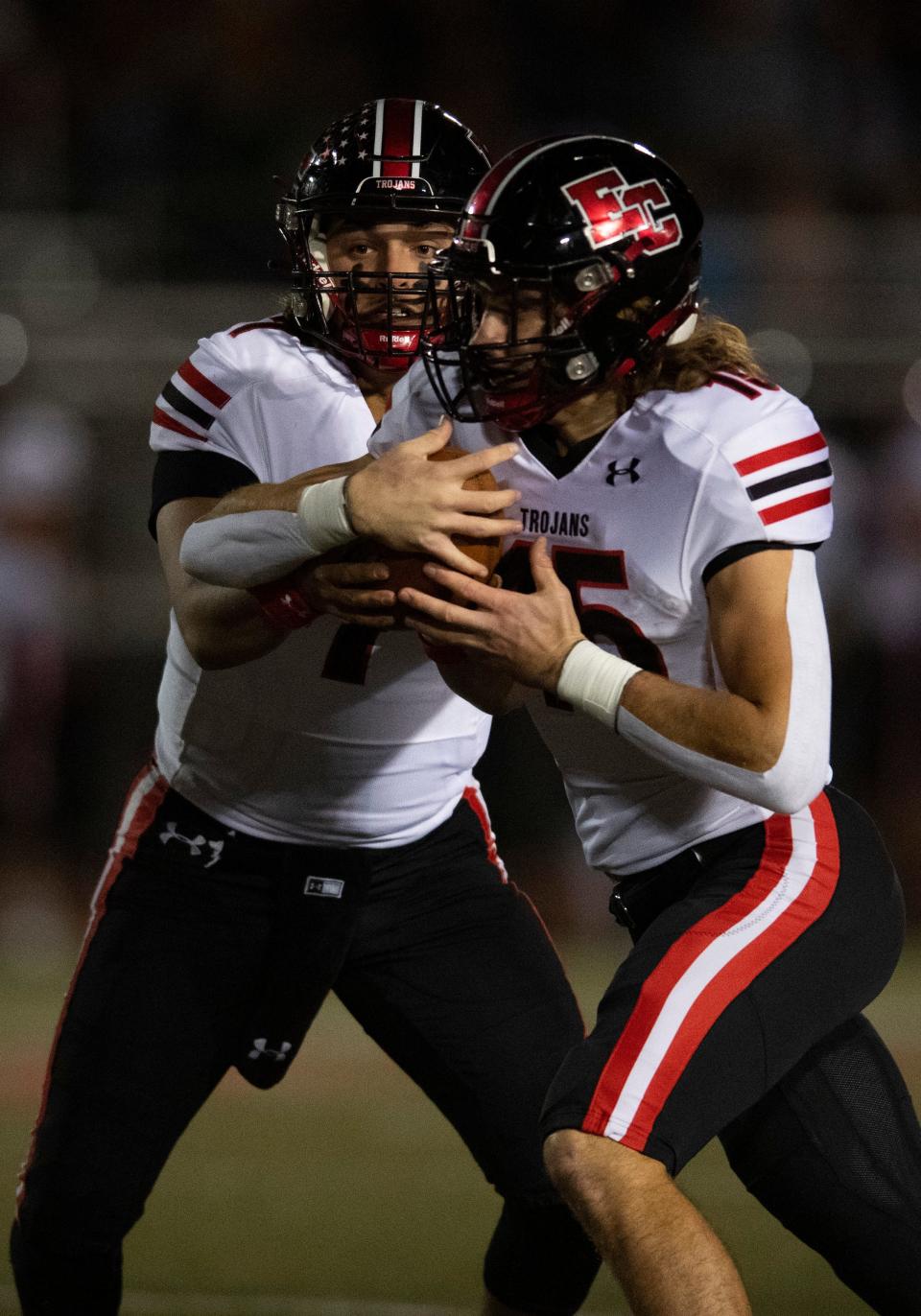 East Central’s Cole Burton (7) hands off to East Central’s Josh Ringer (15) as the East Central Trojans play the Memorial Tigers during the 2023 IHSAA 4A Regional at Enlow Field in Evansville, Ind., Friday, Nov. 10, 2023.