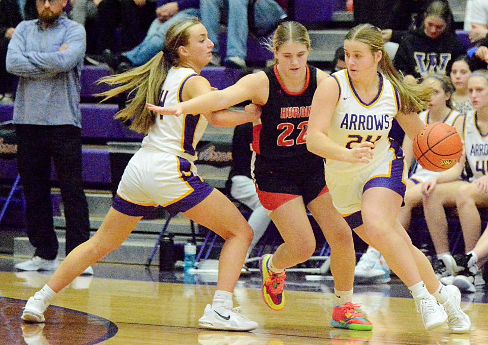 Watertown's Jada Lund (24) attempts to take advantage of a pick by teammate Miranda Falconer (left) to get around Huron's Hylton Heinz during their high school girls basketball game on Tuesday, Jan. 24, 2023 in the Civic Arena.