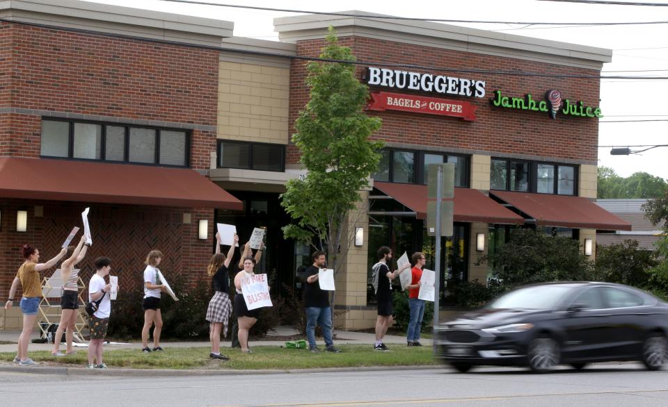 Members of Bruegger's Workers United form a picket line as a car passes by on Saturday, June 15, 2024, at 708 S. Riverside Dr.