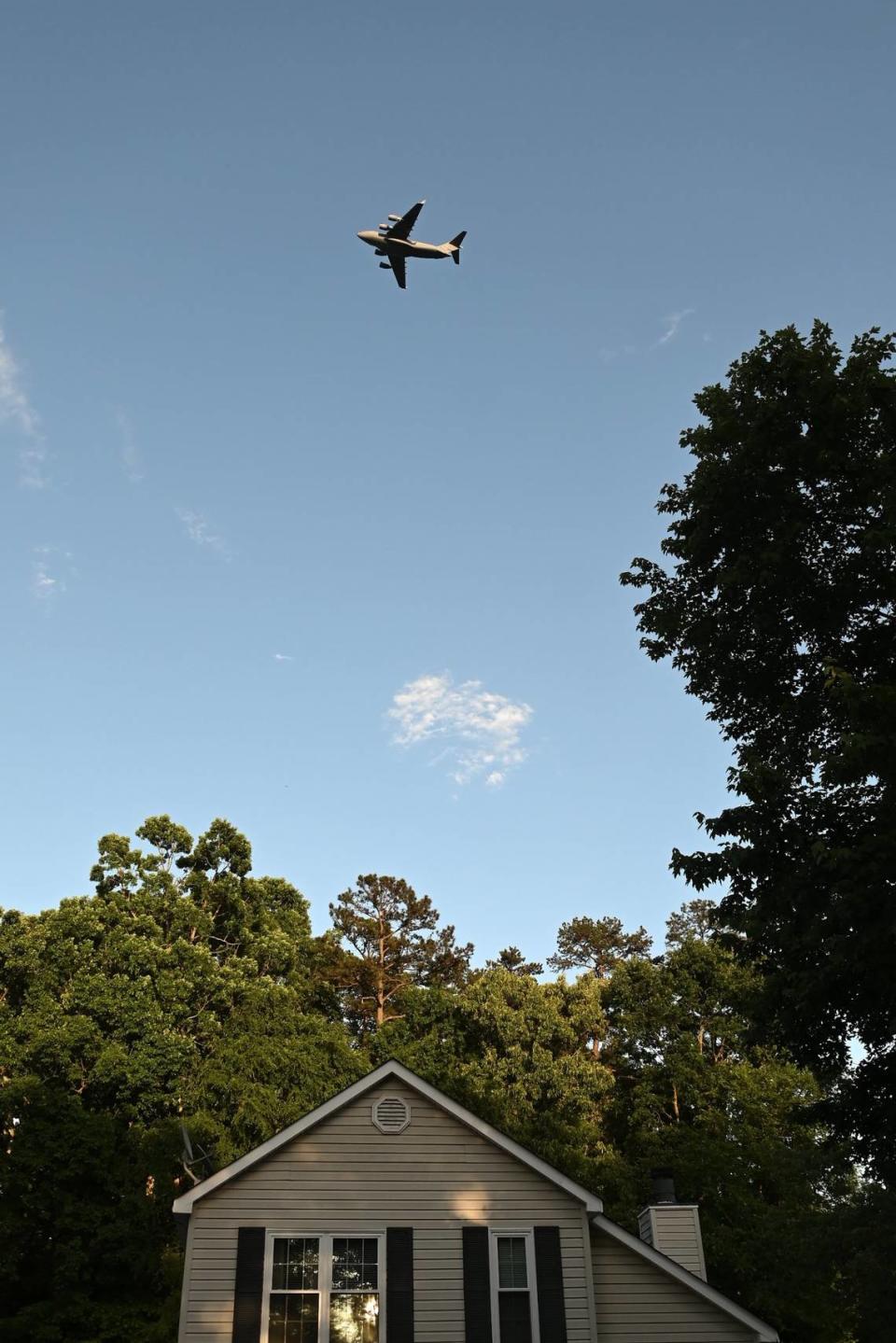 A jet flies over Eagles Landing Drive neighborhood as it leaves Charlotte Douglas International Airport n Charlotte, NC on Tuesday, May 9, 2023.