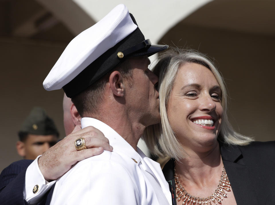Navy Special Operations Chief Edward Gallagher, left, kisses his wife, Andrea Gallagher after leaving a military court on Naval Base San Diego, Tuesday, July 2, 2019, in San Diego. A military jury acquitted the decorated Navy SEAL Tuesday of murder in the killing of a wounded Islamic State captive under his care in Iraq in 2017. (AP Photo/Gregory Bull)