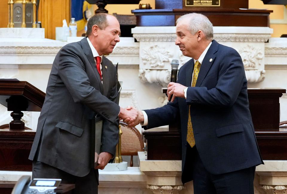 Dec 14, 2022; Columbus, OH, USA;  Ohio Senator Jay Hottinger from Newark shakes hands with Senate President Matt Huffman after receiving a standing ovation during a tribute for his decades of public service in the Senate Chambers. Mandatory Credit: Brooke LaValley/Columbus Dispatch