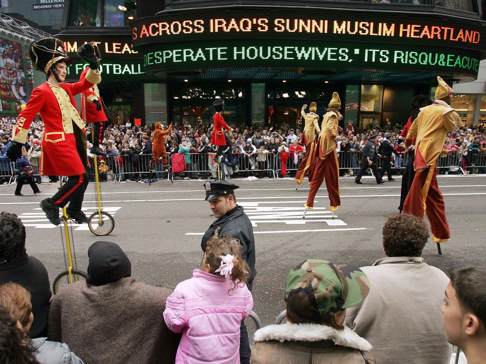 Performers on stilts and unicycles at Macy's thanksgiving day parade 2004