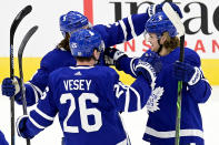 Toronto Maple Leafs defenseman Justin Holl (3) and teammates Jimmy Vesey (26) and Zach Hyman (11) celebrate a goal during the first period of an NHL hockey game against the Montreal Canadiens Wednesday, Jan. 13, 2021 in Toronto. (Frank Gunn/The Canadian Press via AP)