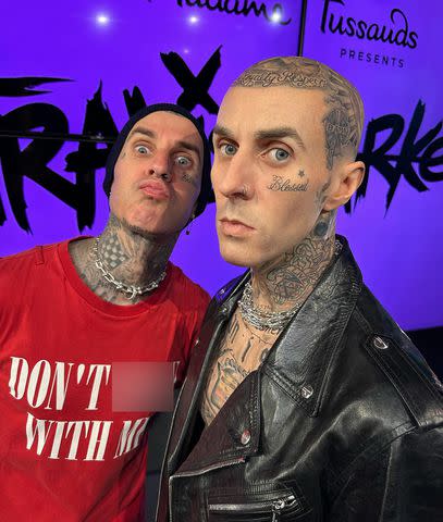 Travis Barker pouted his lips as he posed with his wax figure at Madame Tussauds