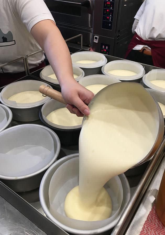 The mix is then poured into tins and aerated some more before being placed into the oven. Photo: Yahoo7 Be