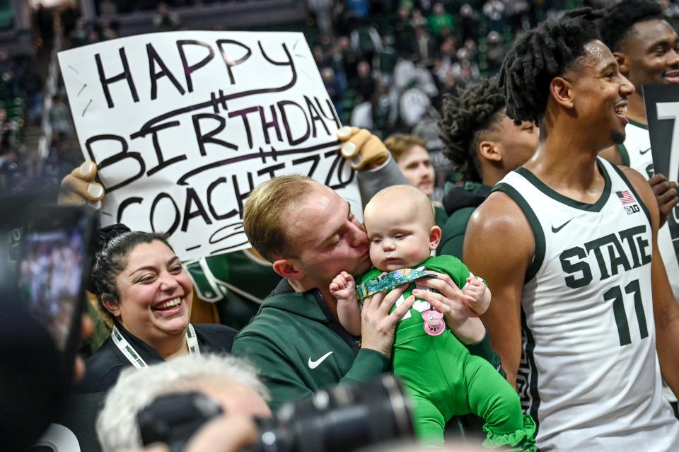 Michigan State's head coach Tom Izzo's daughter Raquel, left, smiles as her brother Steven, center, kisses her daughter Isabelle while celebrating their father's 700th win after the Spartans beat Michigan on Tuesday, Jan. 30, 2024, at the Breslin Center in East Lansing.