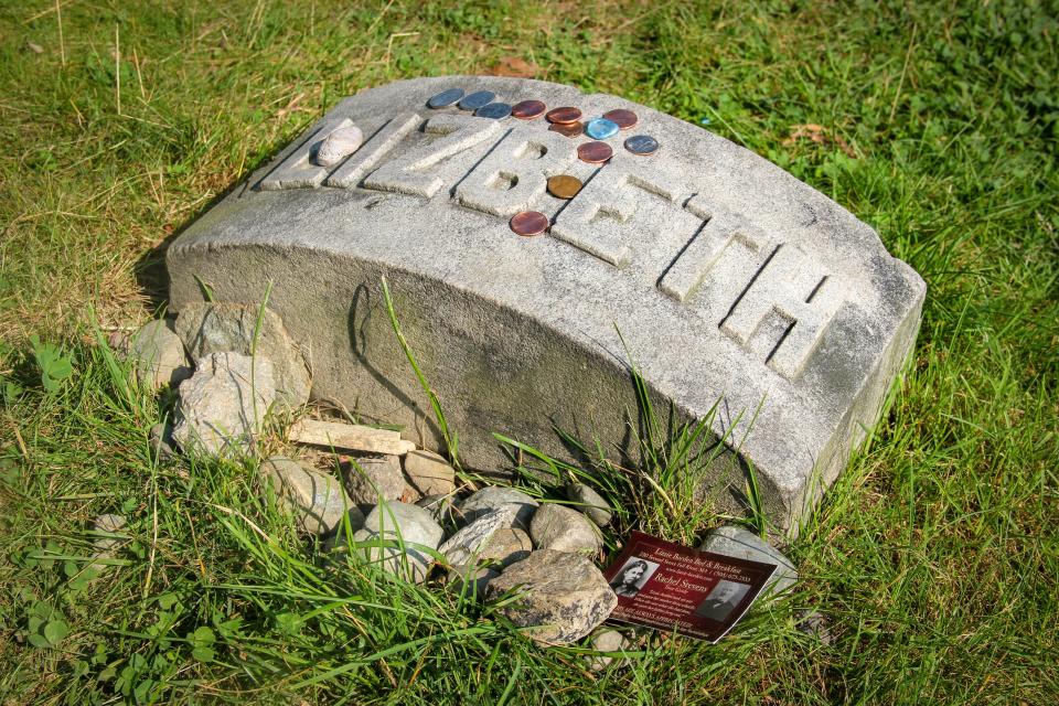 At the grave of Lizzie Borden in Oak Grove Cemetery, people routinely leave coins, stones, and other trinkets in her memory. Someone has left a business card advertising tours for the curious who have visited her grave.