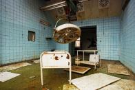 <p>Rusty medical equipment clutters this partially flooded operating room.<br></p>