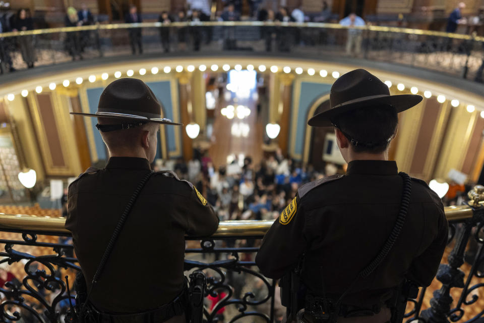 Members of the Iowa State Patrol watch from above as students and supporters gather in the rotunda to protest gun violence during the opening day of the Iowa Legislature, Monday, Jan. 8, 2024, at the Capitol in Des Moines, Iowa. The school walkout and protest were organized by March For Our Lives Iowa in reaction to a school shooting in Perry, Iowa, in which a 17-year-old killed a sixth-grade student and wounded seven other people before authorities say he died of a self-inflicted gunshot wound. (AP Photo/Carolyn Kaster)